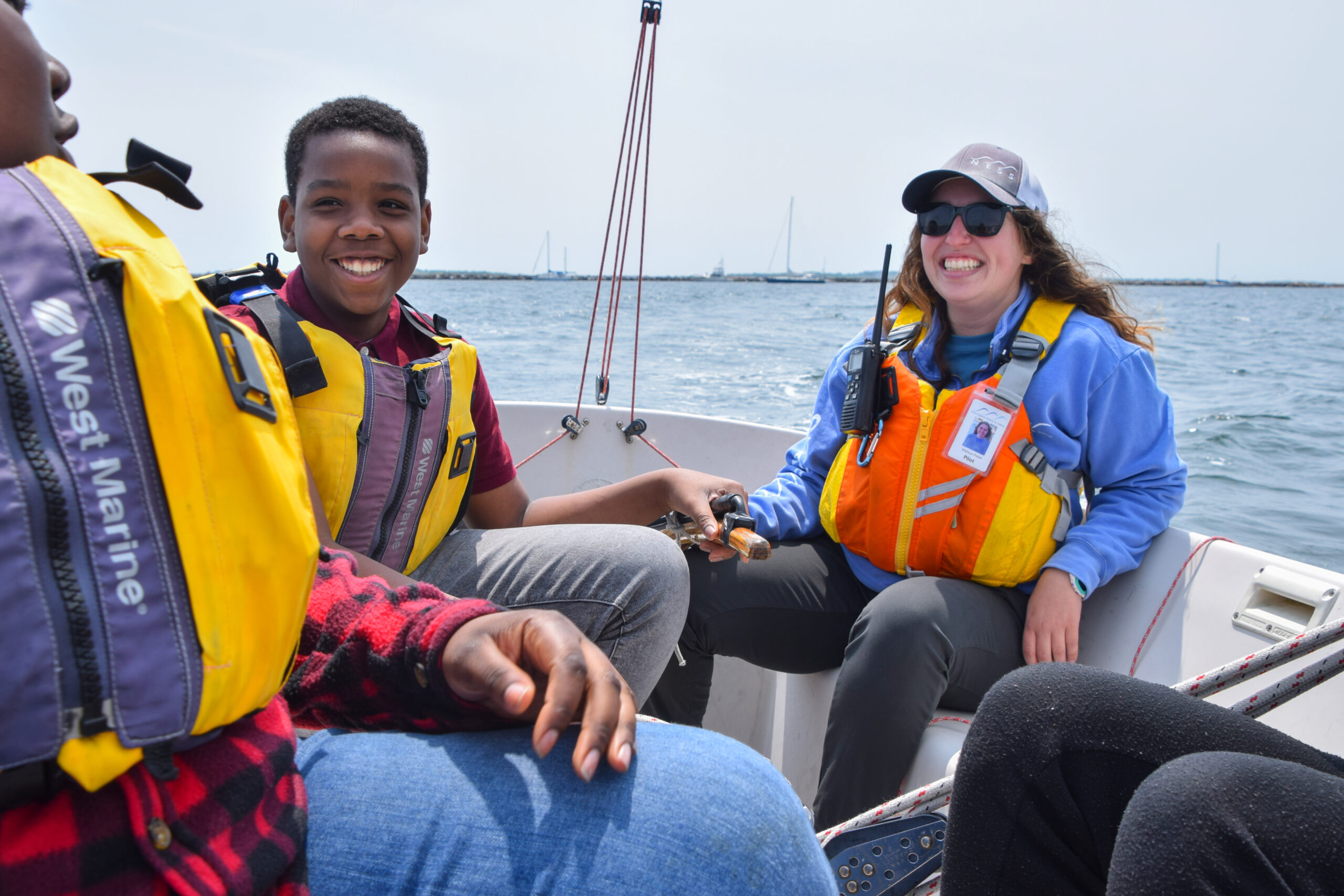 NESS students and instructor sailing a Sonar in Stonington Harbor.
