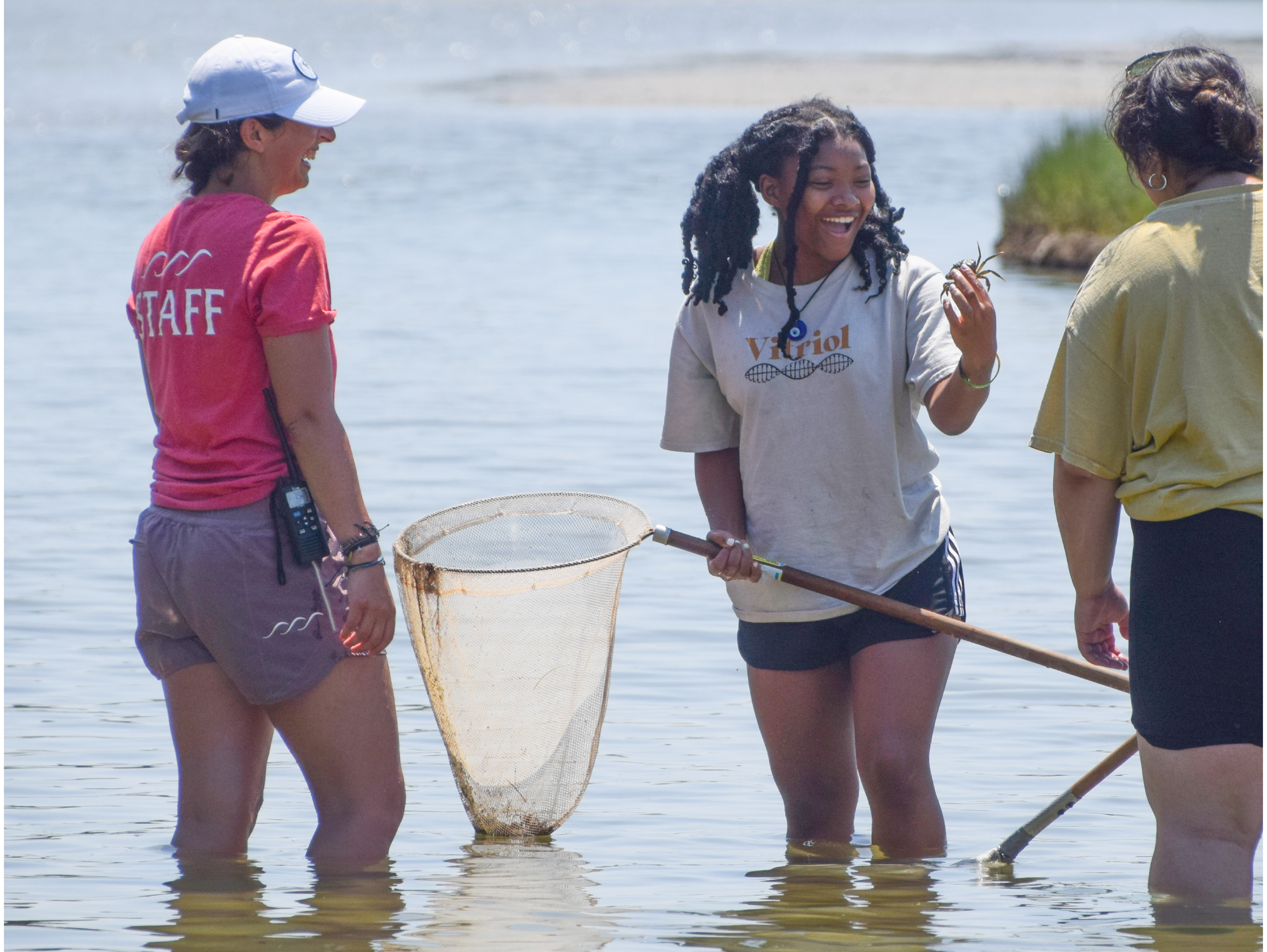 Women and Girls Day - Girl smiling while looking at a crab